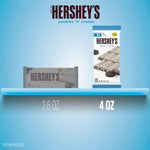 A hand holding the four-ounce packaging of the USA-imported cookies and cream chocolate.