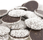 Close up of gourmet semi sweet dark chocolate discs with white sugar seeds