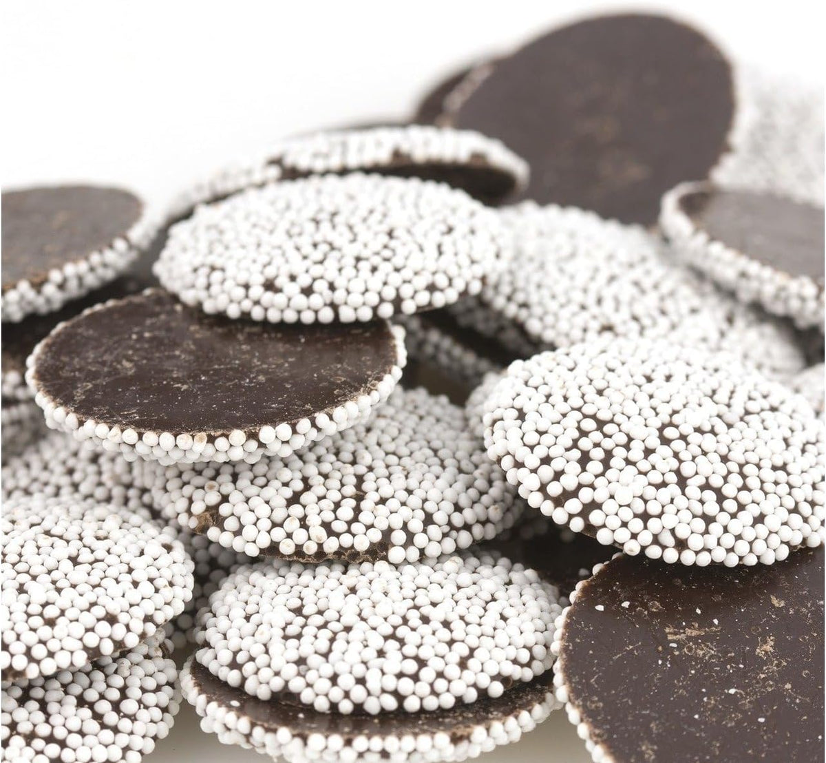 Close up of gourmet semi sweet dark chocolate discs with white sugar seeds