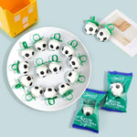 Wearable soccer ball sucker candy being held up to show the ring design.