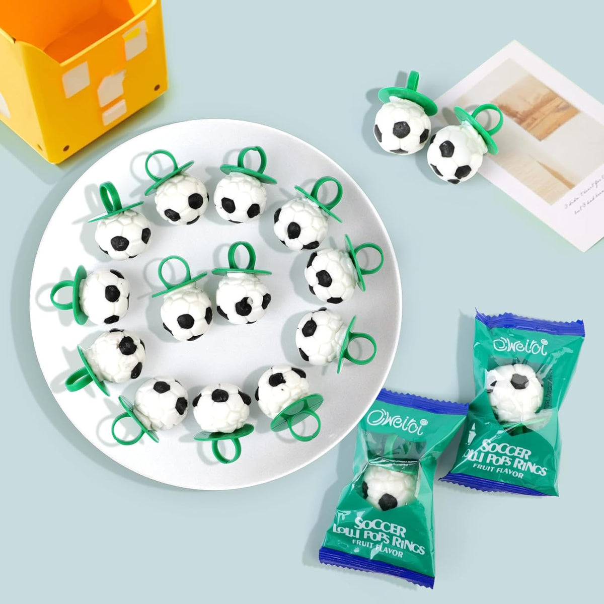 Wearable soccer ball sucker candy being held up to show the ring design.