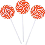 Two inch round pink spiral lollipops showing the individual packaging and sturdy sticks.