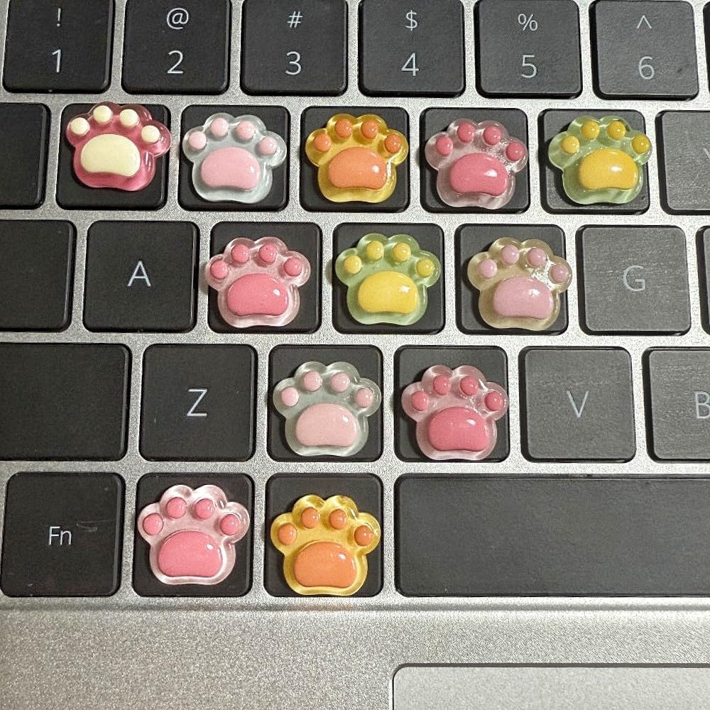 MayeBridge cute 3D cat paw keyboard key caps front view on a pink laptop keyboard.