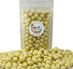 Creamy white chocolate coated espresso candy poured in a serving bowl displaying glossy finish.
