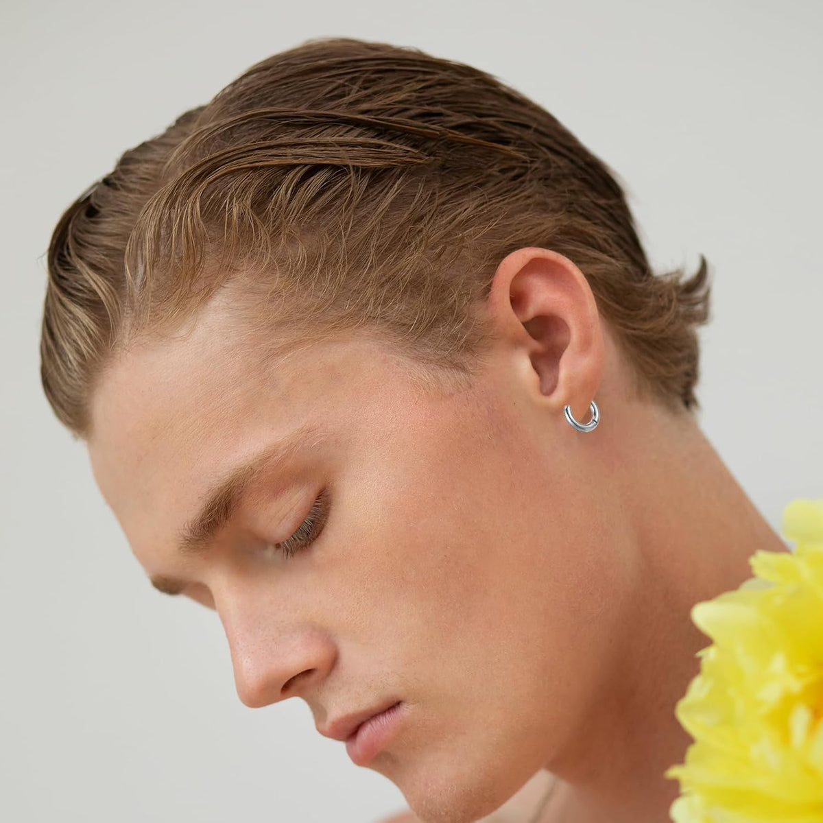 Close-up of the 13mm black hoop earring highlighting its polished surface.