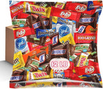 Individually wrapped snack size party chocolate mix scattered on a surface