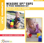 Toddler hands stacking and nesting volumetric math cups