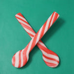 Festive holiday candy shot glasses and peppermint stirrers set close up