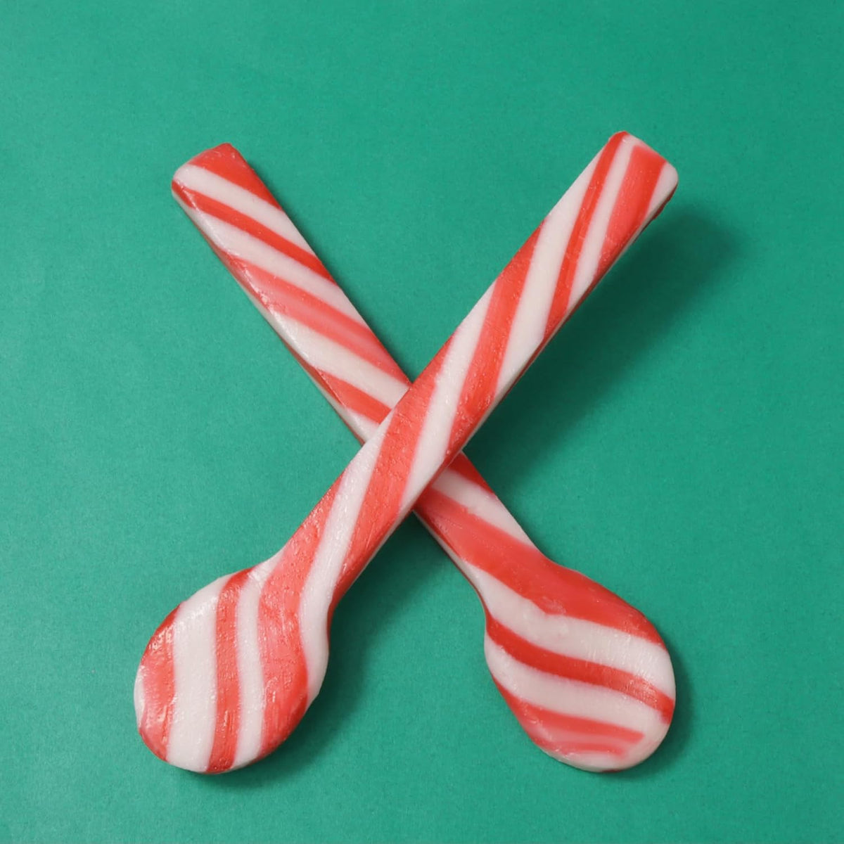 Festive holiday candy shot glasses and peppermint stirrers set close up