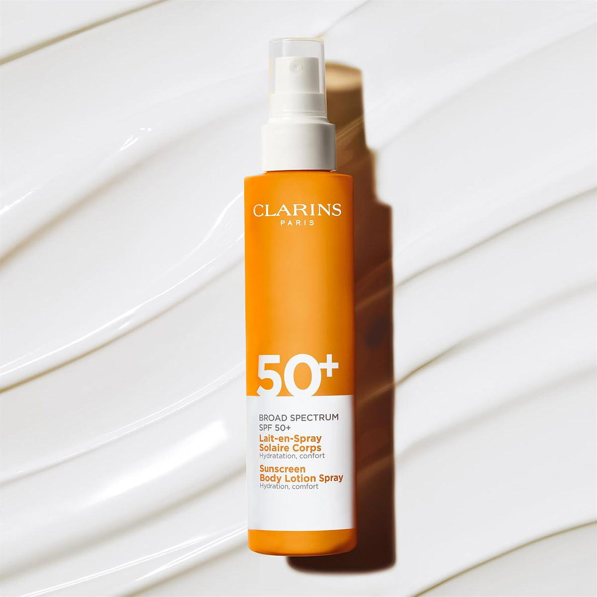Clarins sunscreen lotion texture sprayed on skin surface