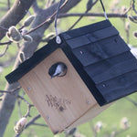 Natures Way Cedar Wren House placed in garden setting