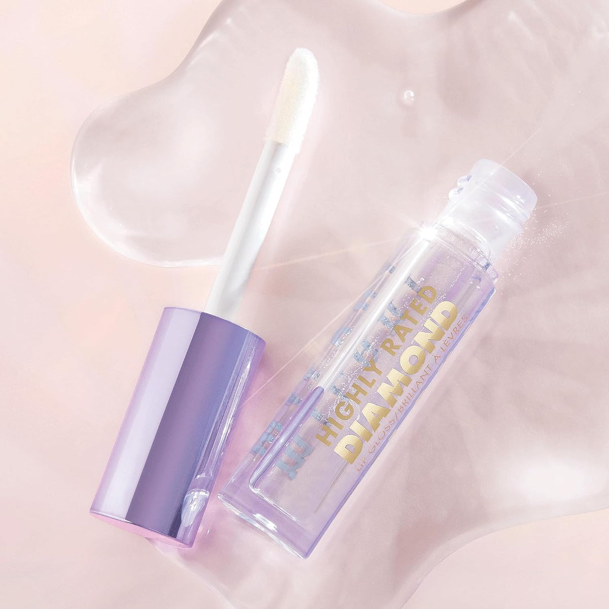 Milani clear optical lip plumper applicator wand being removed from the tube.