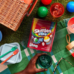 Puffed rainbow color freeze dried candies spilled out on table