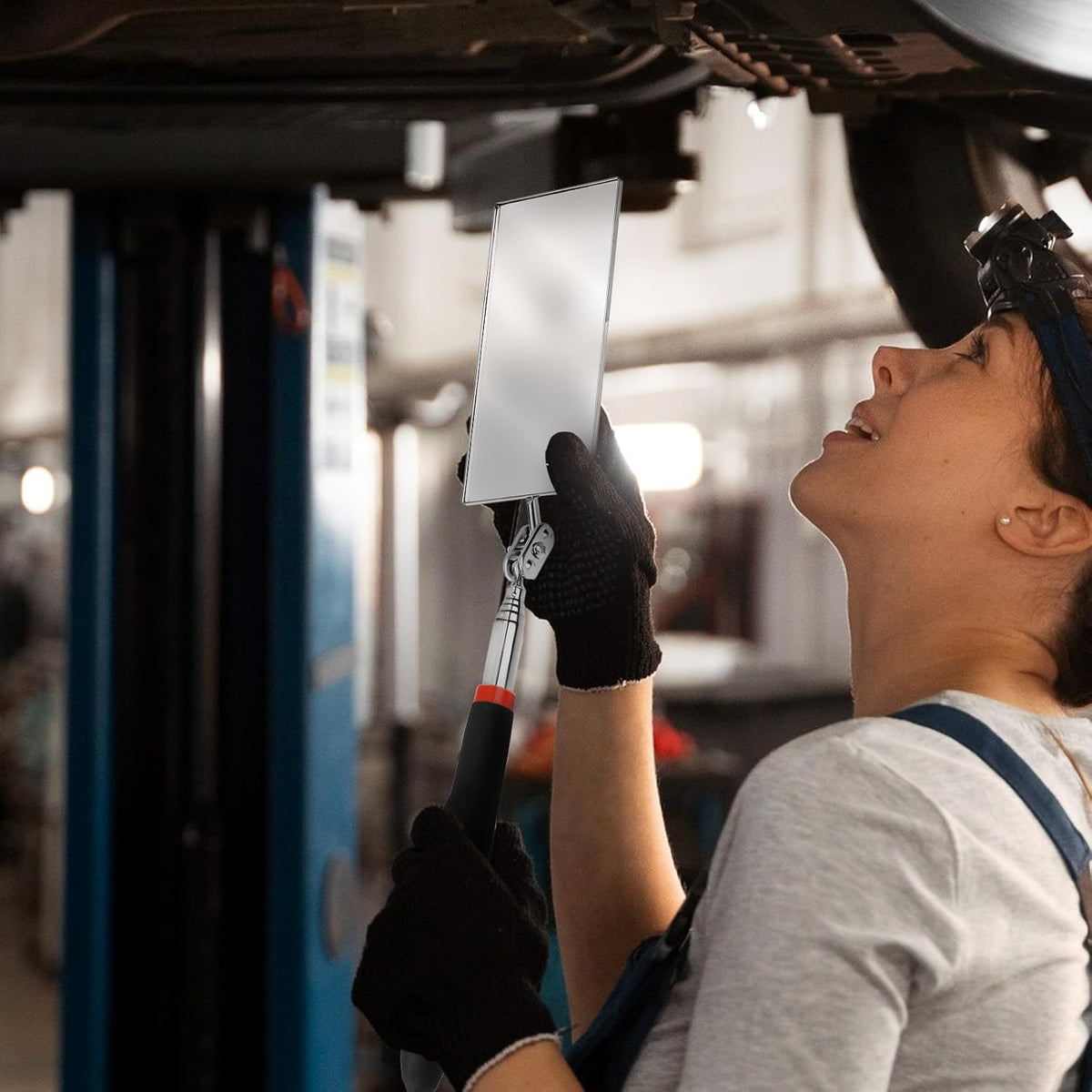 EupHHonycs mechanic mirror being used for vehicle inspection