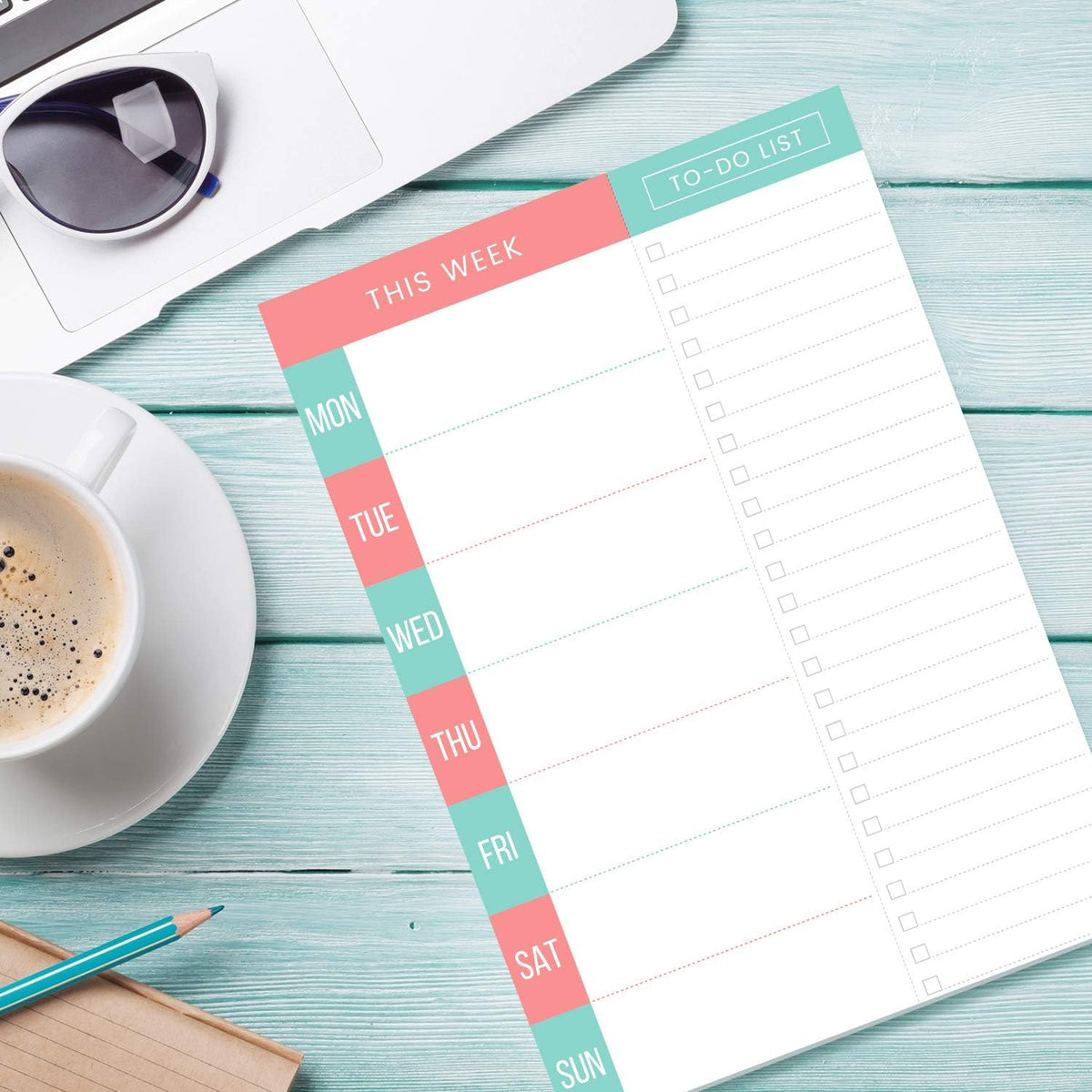 Planner pad mounted securely on a refrigerator surface in a kitchen.