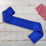 Model wearing dark blue customizable pageant sash at a party event