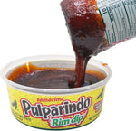 Tamarind candy paste being used to rim a michelada glass