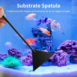 Curved stainless steel aquarium scissors executing clean trims on underwater greenery