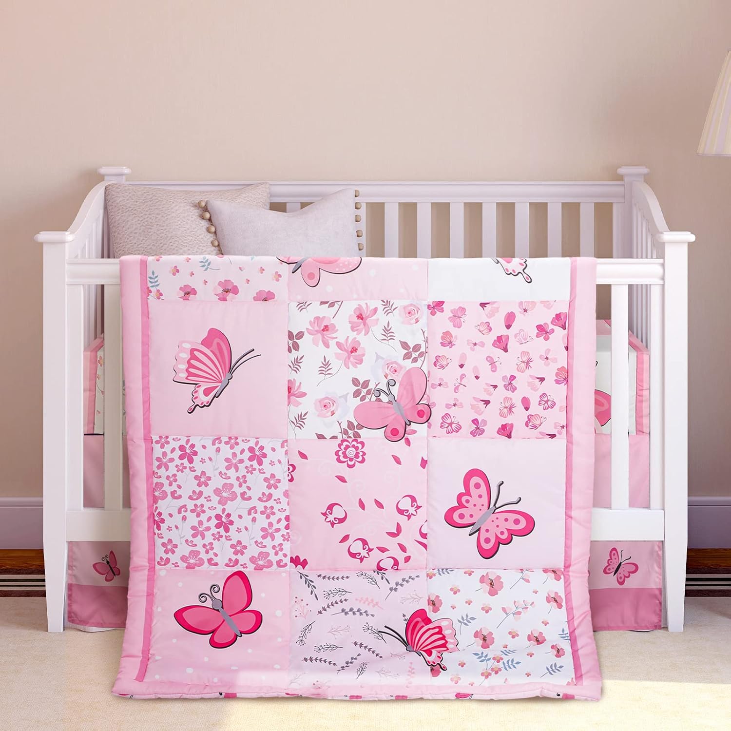 Tudomro butterfly crib bedding set front view showing pink patchwork comforter on a baby crib.