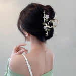 Oh Soo Pink Floral Hair Claw Clip front view showing white petals and green leaves