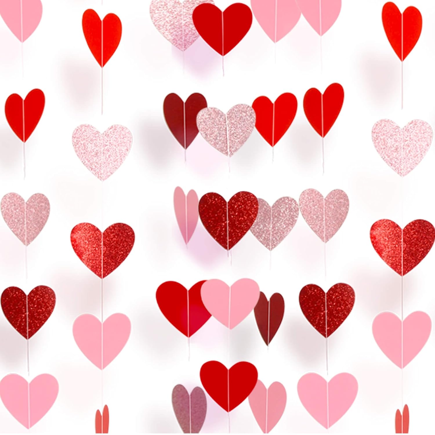 Sincey pre-strung paper heart garland front view hanging against a white wall for anniversary decoration