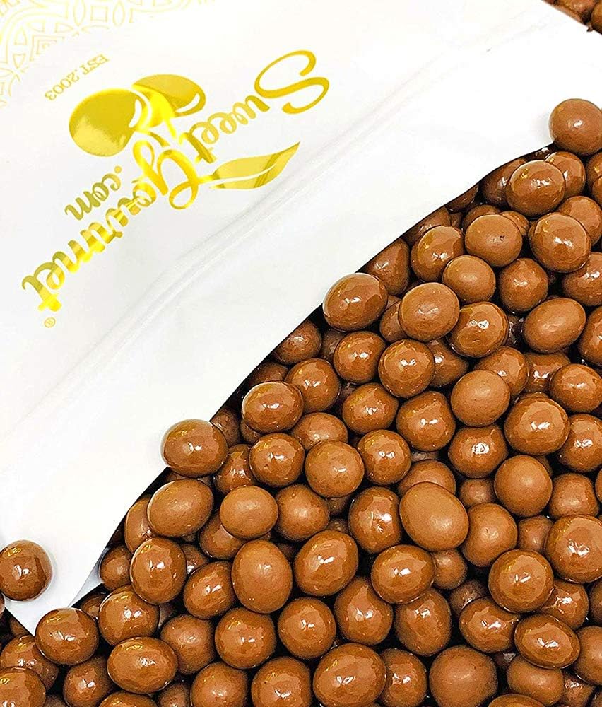 Premium milk chocolate espresso beans poured into a white serving bowl