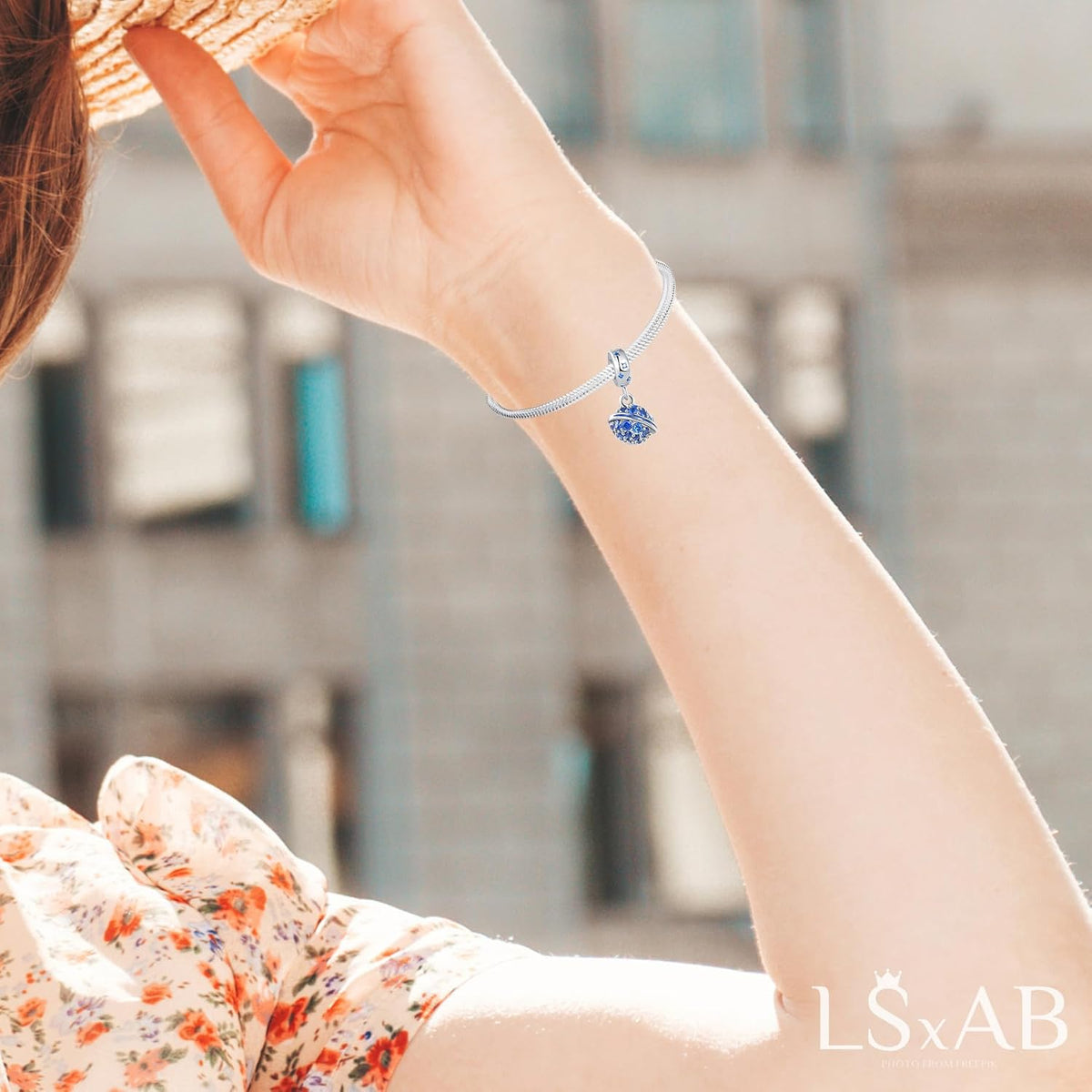 LSxAB blue planet charm styled on a standard women's charm bracelet