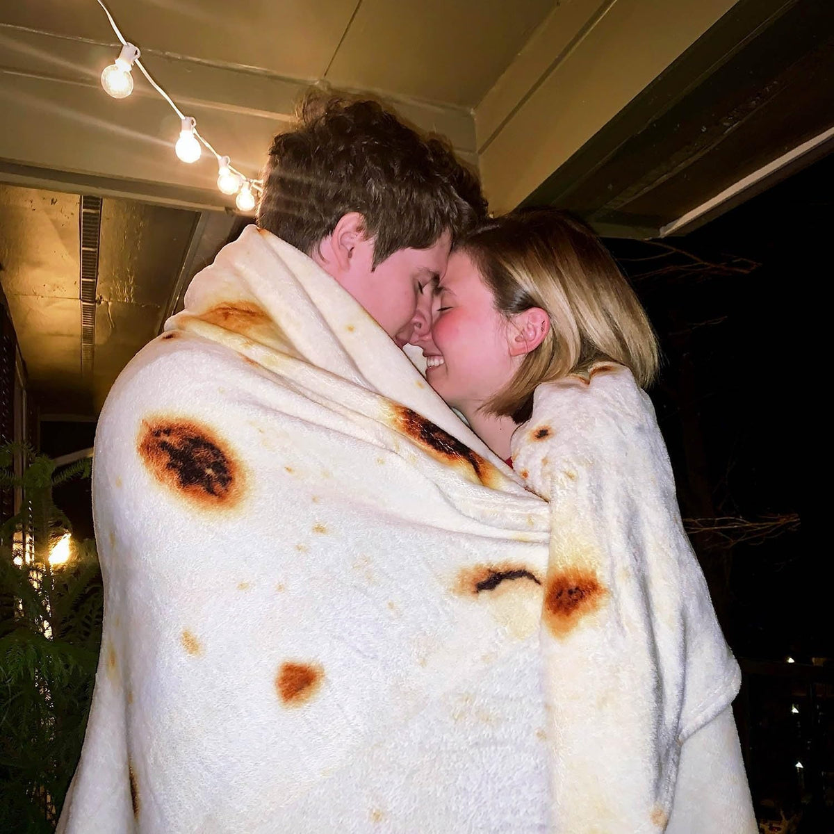 Person wrapped inside the giant 74in tortilla blanket like a burrito.