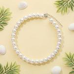 Fengek domestic cat wearing elegant ten millimeter faux pearl costume accessory.