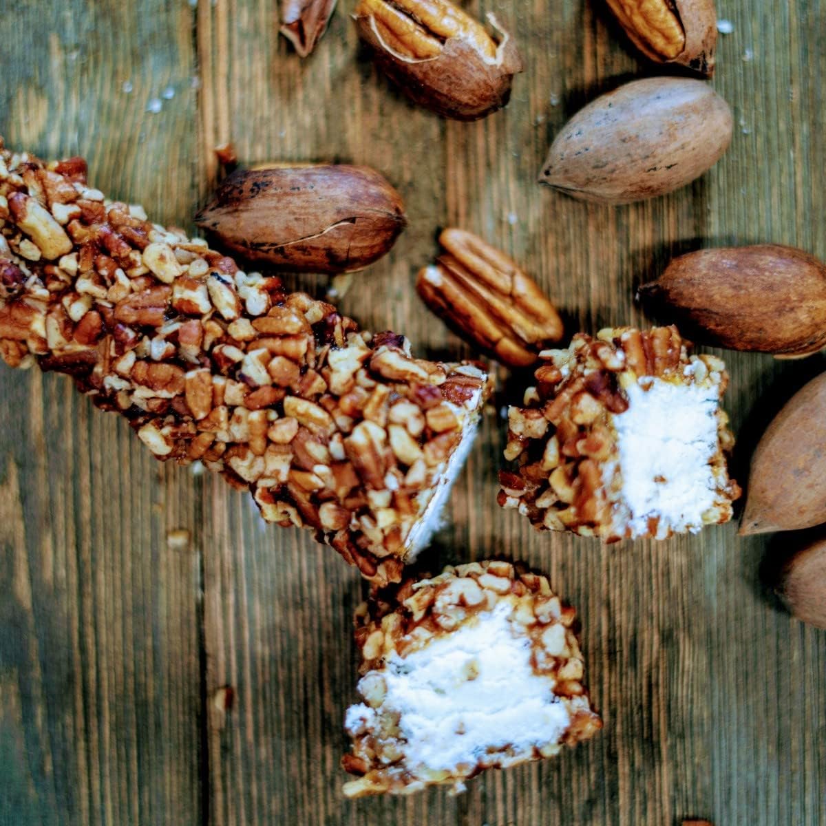 Three individually wrapped gourmet caramel pecan logs displayed next to packaging