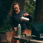 Stanley durable travel flask standing on a rustic outdoor surface