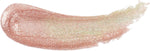 Milani Luster Light lip topper swatched next to the product bottle highlighting the iridescent shimmer finish