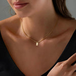 Close-up of the square letter tag charm on a delicate box chain