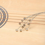 Full pack of 10 replacement guitar strings ready for installation.