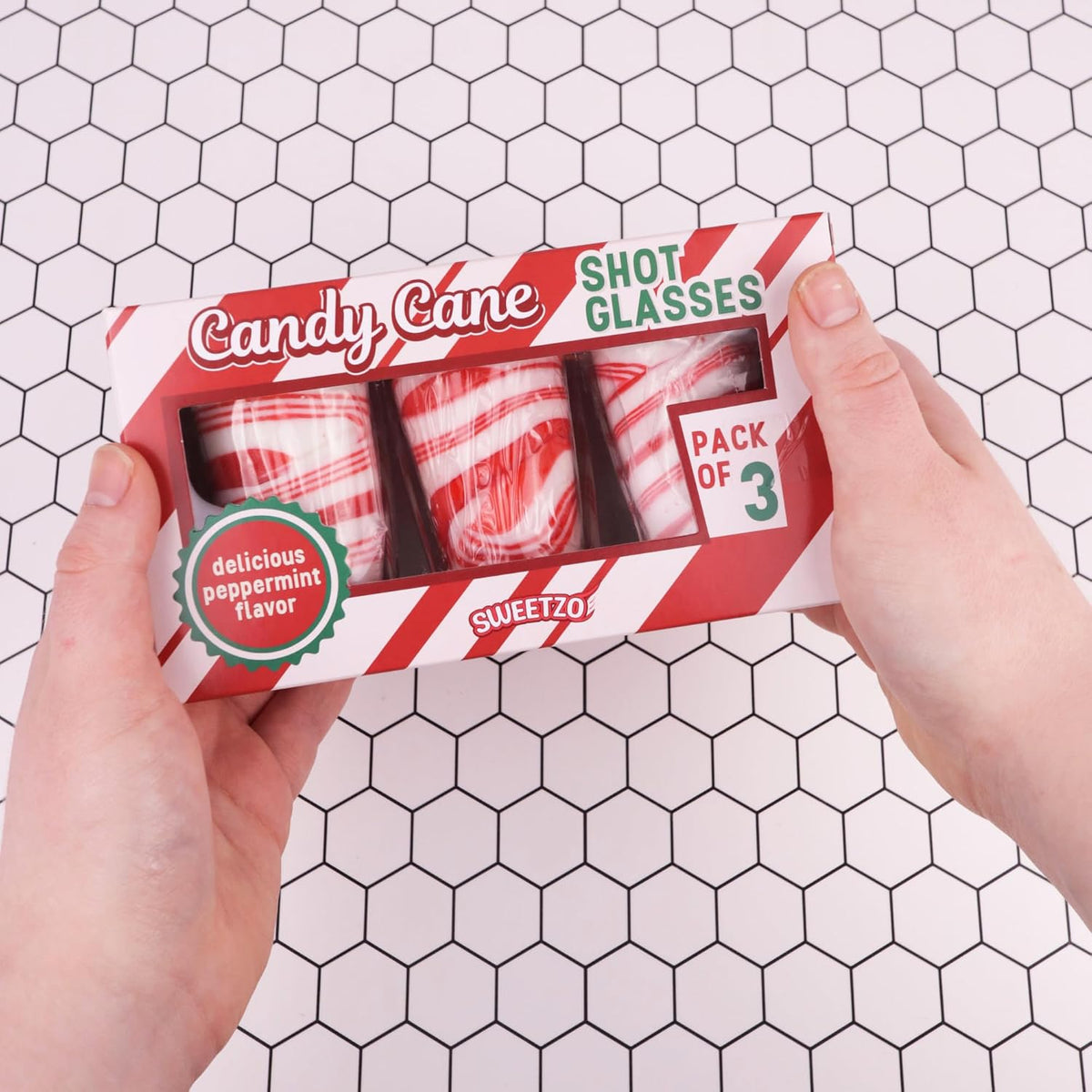 Sweetzo edible peppermint spoons dipping into a cup of hot chocolate
