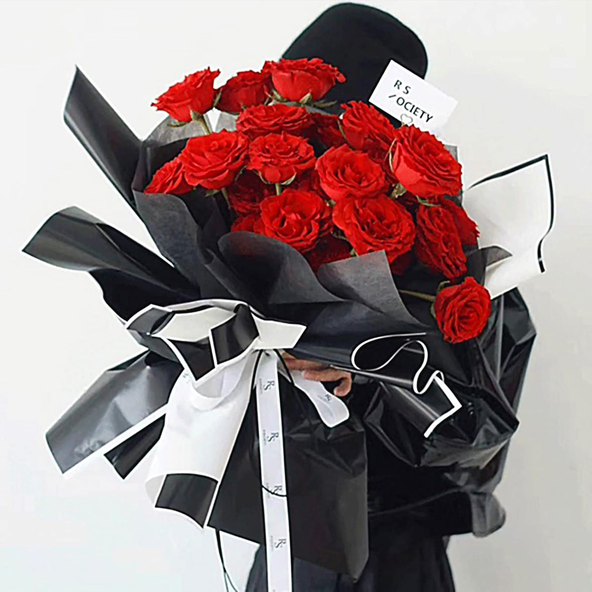 Stack of 22.83 inch square florist bouquet wrapping supplies.