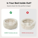 Cat resting comfortably inside cream colored round pet bed