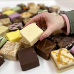Gourmet white chocolate candy block inside the open luxury snack box.