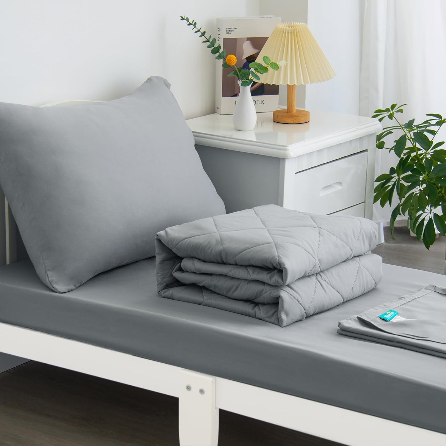 Biloban 4 Piece Toddler Bedding Set front view featuring the grey quilted comforter and matching sheets on a standard crib mattress.