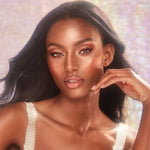 Charlotte Tilbury skincare infused lip gloss tube with rose gold starburst pattern