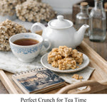 Sugarless peanut brittle pieces with whole roasted peanuts on a rustic background