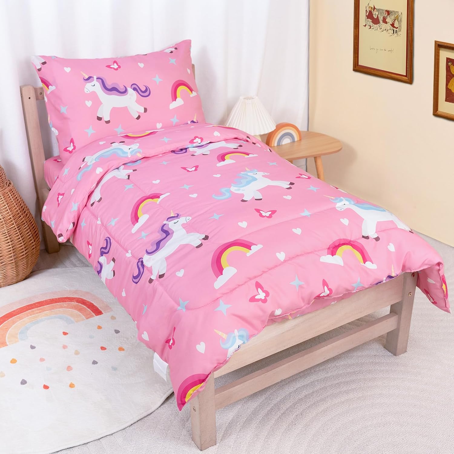 TinyPalsa toddler bedding set front view featuring pink rainbow pony design on a neat crib mattress.