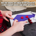 Cutting dark green felt fabric with scissors
