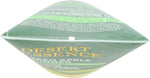 Desert Essence hair care bottle next to fresh green apple