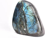 Jic Gem upright worry stone angled under bright illumination.