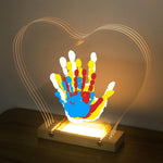 Bixinyo family handprint kit with light front view showing glowing heart shape