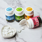 DC24 Daily Care xylitol and erythritol blended sugarless gum individual pieces shown outside the bottle