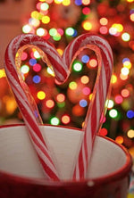 Ten boxes of MAJUU CONNECT candy canes stacked to demonstrate the bulk quantity