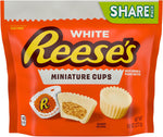 Close-up of a bite-sized white creme peanut butter cup showing the smooth outer texture.
