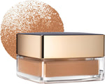 Estee Lauder non acnegenic face powder being dispensed onto a makeup brush.